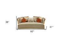 41" Beige Velvet Curved Sofa And Toss Pillows With Natural Legs